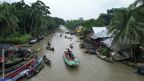 Wooden and metal boats are seen in the river which is the floating market of Bangladesh