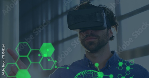 Image of human brains spinning and data processing over businessman wearing vr headset