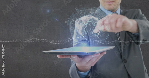 Image of globe and data processing over businessman holding tablet