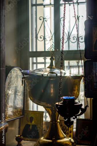 Church inventory in the Russian Orthodox Church of Archangel Michael in the village of Kutepovo. Sunlight and baptismal font