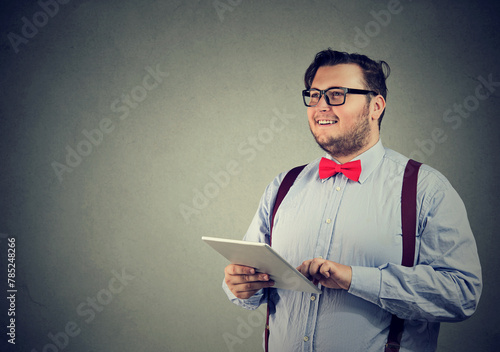 Happy smiling businessman with a tablet computer 