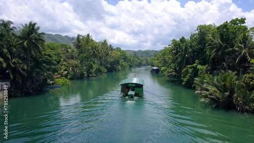 Following one of the boats of the Loboc river cruise, one of the popular attractions in Bohol, Philippines.