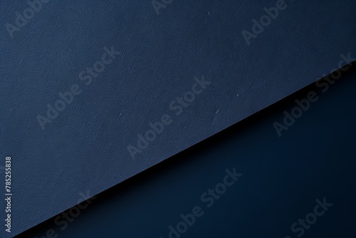 Navy Blue background with dark navy blue paper on the right side, minimalistic background, copy space concept, top view, flat lay photo