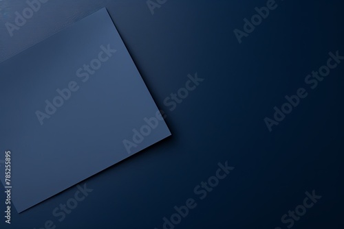 Navy Blue background with dark navy blue paper on the right side, minimalistic background, copy space concept, top view, flat lay