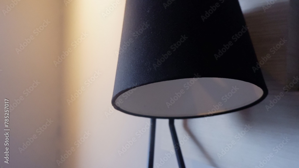 a close up photo of a desk lamp hood in hotel