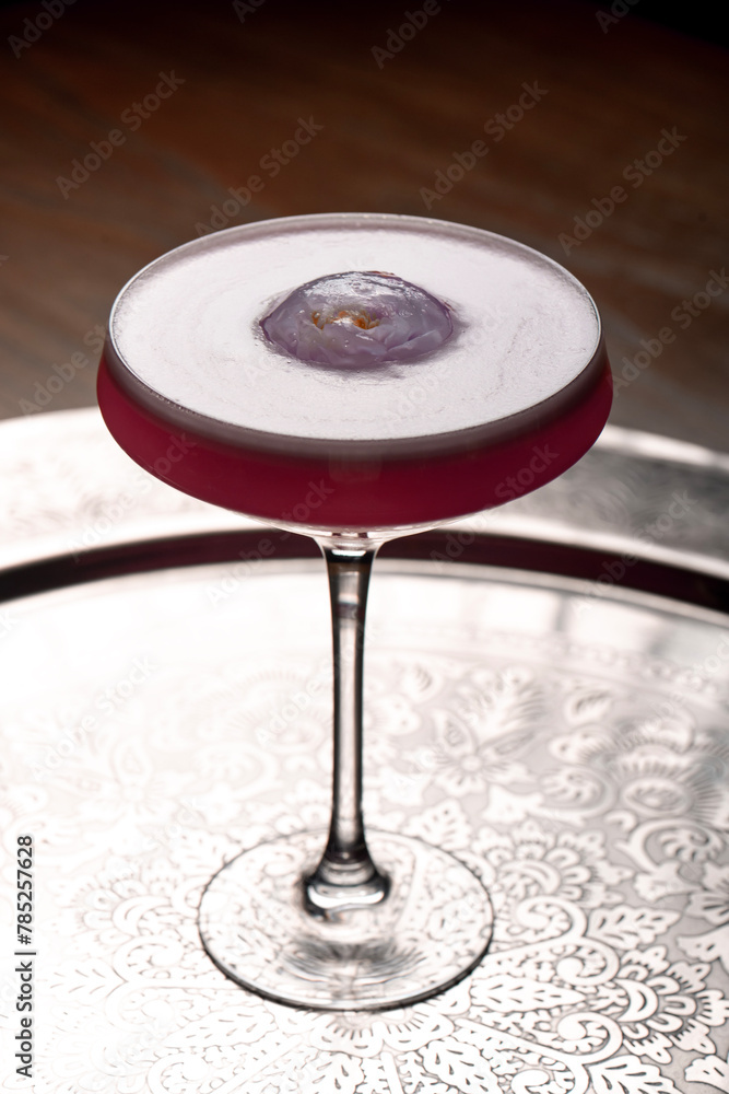 Cocktail in a martini glass on a dark background. Cocktail in a martini glass on a dark background.