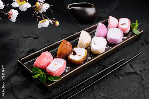 Assorted mochi ice cream on dark slate background photo