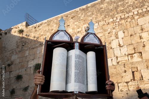 A sefardi Torah scroll is lifted toward the sky during Jewish prayers at the Western Wall in Jerusalem, Israel.
