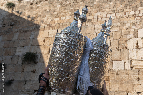A sefardi Torah scroll is lifted toward the sky during Jewish prayers at the Western Wall in Jerusalem, Israel.