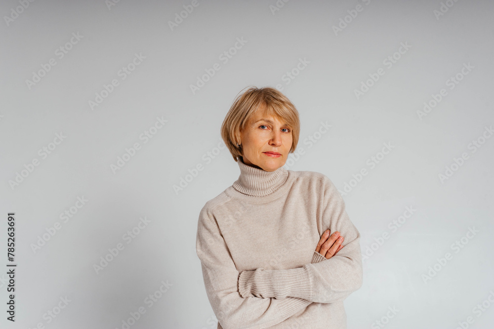 Beautiful adult casual woman in a sweater standing confident and curious Beautiful adult casual woman in a sweater standing confident and curious