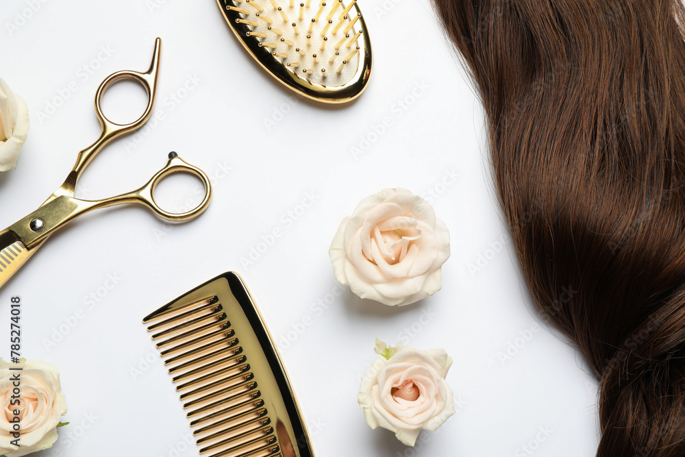Naklejka premium Flat lay composition with different hairdresser tools and flowers on white background