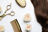 Flat lay composition with different hairdresser tools and flowers on white background