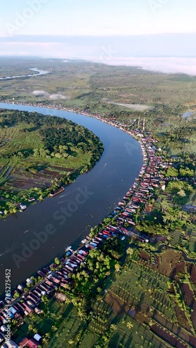 View of a residential village on the riverbank of South Kalimantan from a drone during the day