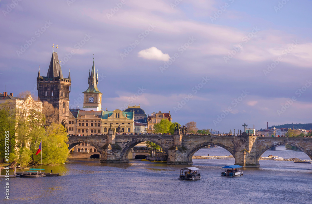 Charles Bridge (Karluv Most) on Vltava river and Old Town Bridge Tower, famous tourist destination in Prague, Czech Republic (Czechia), at sunset