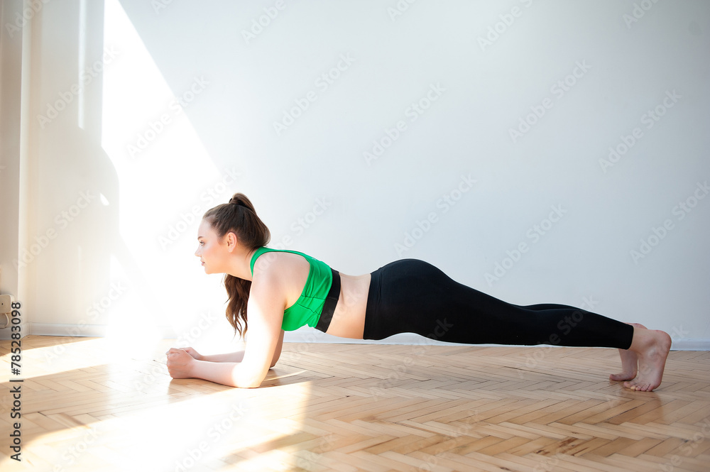 woman in sportswear doing fitness at home
