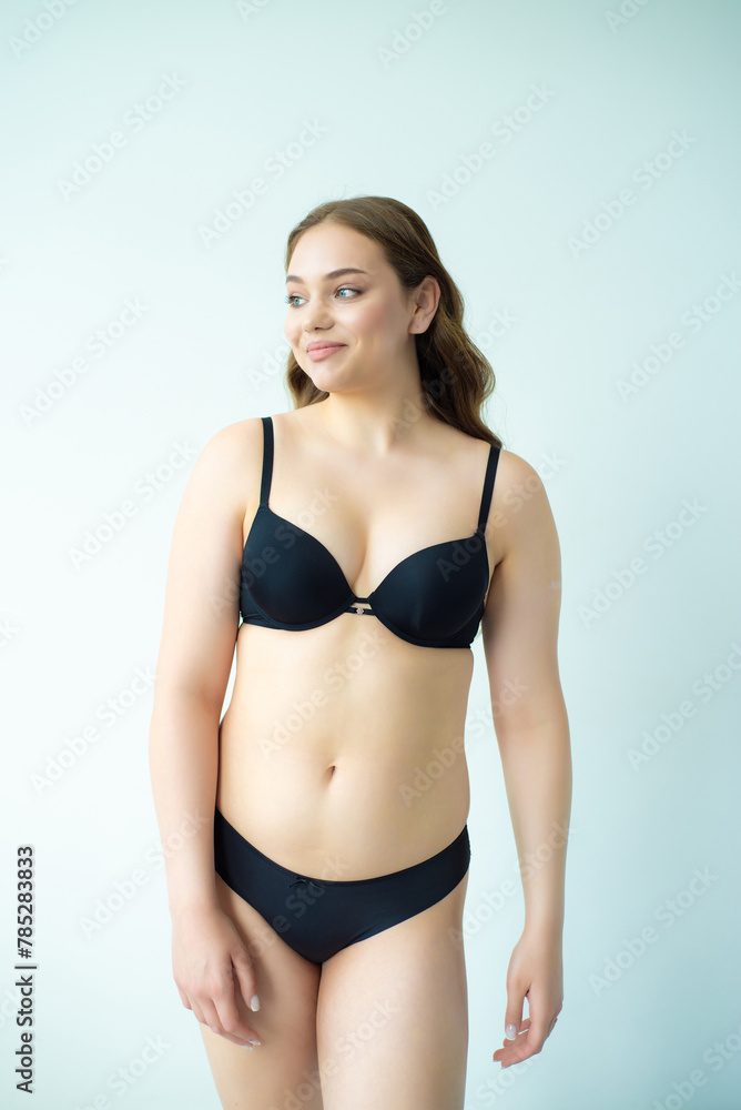 Obraz premium young woman with beautiful hair in black lingerie posing isolated on white background. Model test, snap, polaroid