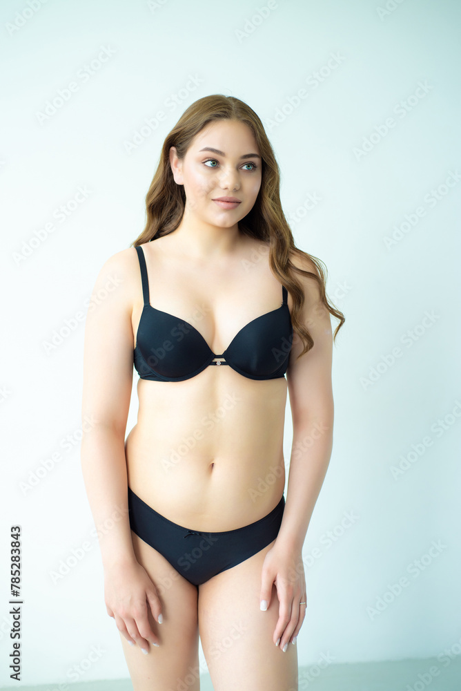 Obraz premium young woman with beautiful hair in black lingerie posing isolated on white background. Model test, snap, polaroid
