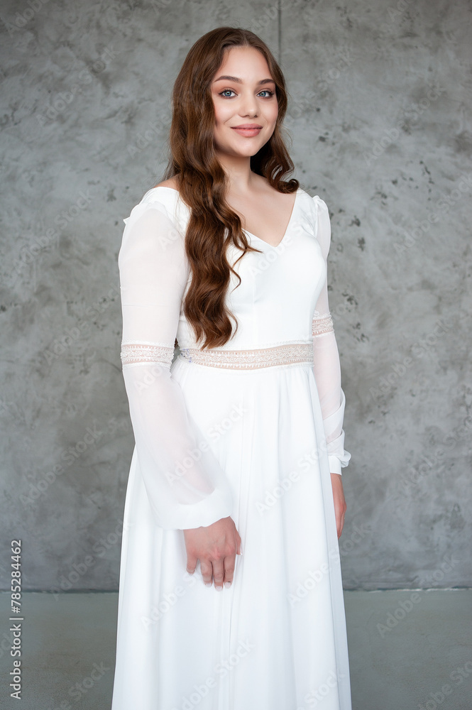 portrait of beautiful young woman in white wedding dress posing in studio. portrait of beautiful young woman in white wedding dress posing in studio.