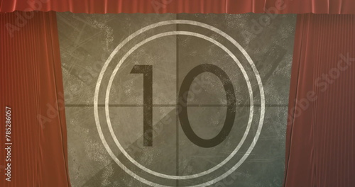 Image of vintage movie countdown in circle over brown curtains