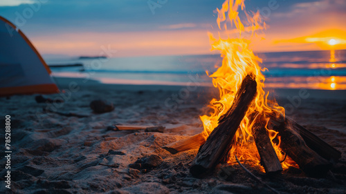 Vacationers light a campfire on the beach in summer. Adventurers camping on the beach at sunset. Summer concept. Happy days.  photo