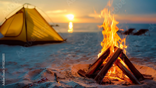 Vacationers light a campfire on the beach in summer. Adventurers camping on the beach at sunset. Summer concept. Happy days. 