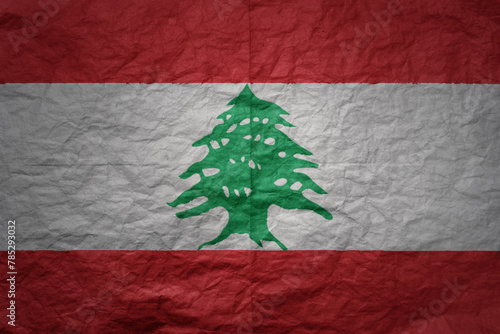 big national flag of lebanon on a grunge old paper texture background photo