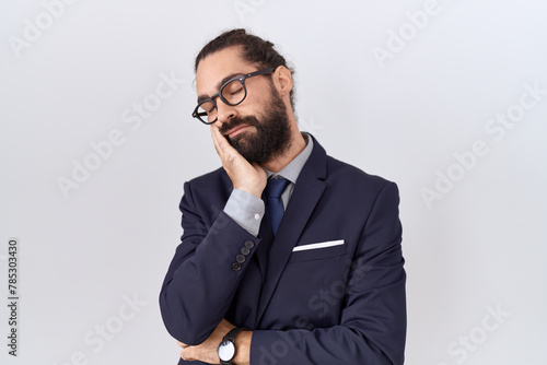 Hispanic man with beard wearing suit and tie thinking looking tired and bored with depression problems with crossed arms. photo