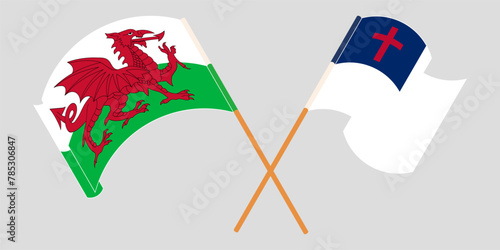 Crossed and waving flags of Wales and christianity