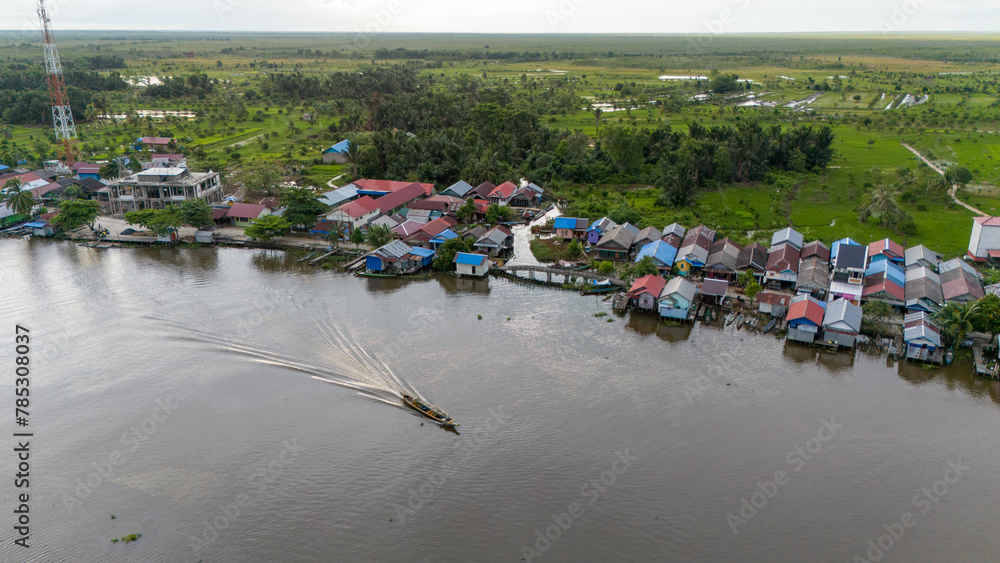 Fototapeta premium View of a residential village on the riverbank of South Kalimantan from a drone during the day