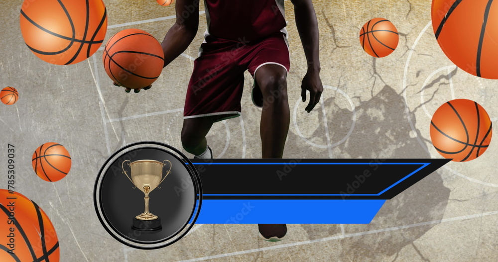Image of trophy and empty banner over male player and basketballs over basketball court