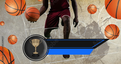 Image of trophy and empty banner over male player and basketballs over basketball court