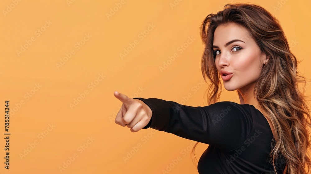 Portrait of beautiful young woman pointing with finger at copy space. Portrait of beautiful young woman pointing with finger at copy space.