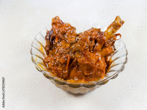Spicy Indian chicken gravy masala curry, cooked in Bengali style in closeup. © Roop Dey