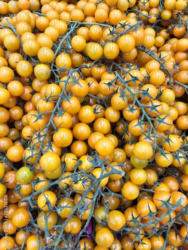 cherry tomatoes on a branch. close up. Food background.store shelves with vegetables