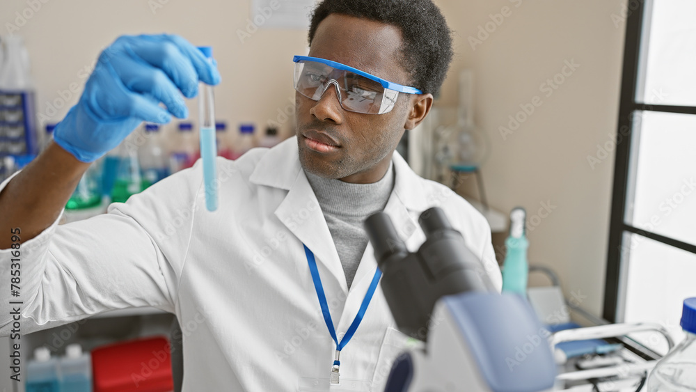 African american scientist analyzing a test tube in a laboratory setting, exemplifying healthcare research. African american scientist analyzing a test tube in a laboratory setting, exemplifying healthcare research.