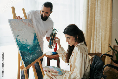 loving cheerful couple of bearded man and disabled woman painting on easel together at home