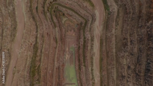 Aerial fly over over croft quarry digging abandoned site with gravel road and no machinery. Layers and natural earth resources  photo