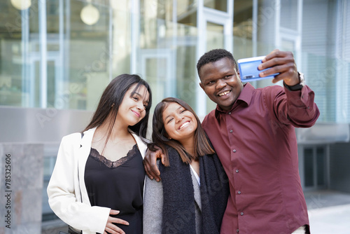 Multi-ethnic friends taking a selfie in the city