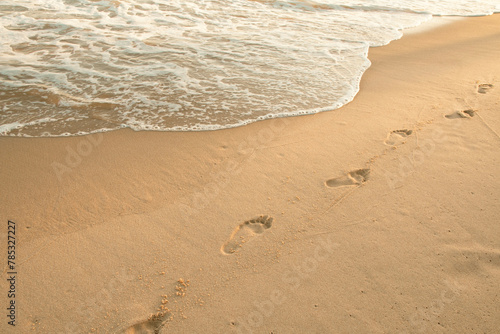 footprint of people on the sand of the sea with waves