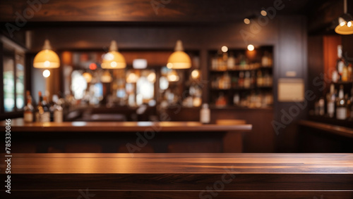 A wooden bar with bottles on shelves behind it photo