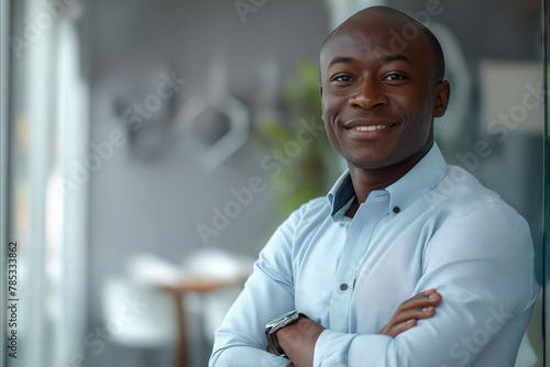 A smiling african man in a blue shirt.