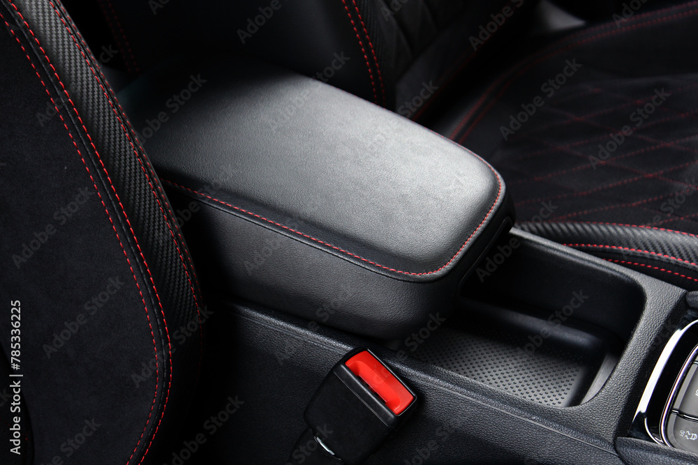 Armrest in the car for driver. Car armrest. Armrest between front seats inside the car. Luxury car interior background.