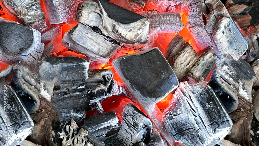 Barbecue Grill Pit With Glowing And Flaming Hot Charcoal Briquettes, Close-Up Barbecue Grill Pit With Glowing And Flaming Hot Charcoal Briquettes, Close-Up