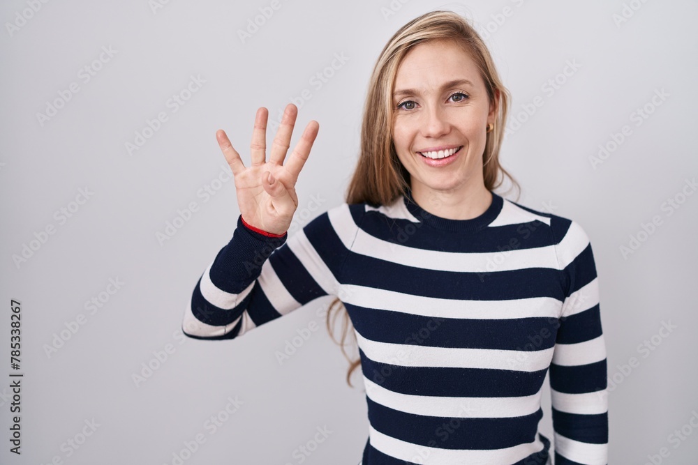 Young caucasian woman wearing casual navy sweater showing and pointing up with fingers number four while smiling confident and happy. Young caucasian woman wearing casual navy sweater showing and pointing up with fingers number four while smiling confident and happy.