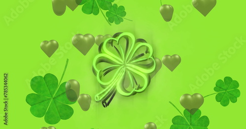 Image of st patrick's day shamrock and green hearts on green background
