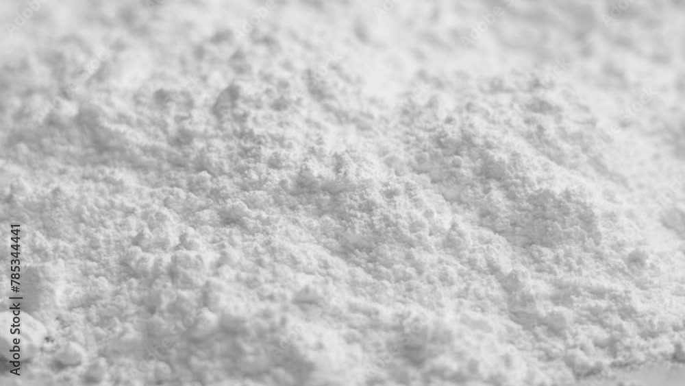 Magnesium bisglycinate supplement white powder close up. Rotation