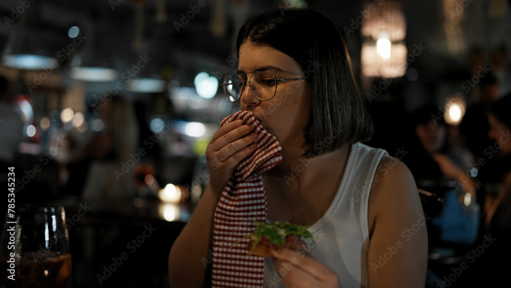 Young beautiful hispanic woman eating delicious italian food at the restaurant Young beautiful hispanic woman eating delicious italian food at the restaurant