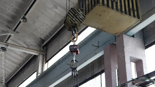 The work of an overhead crane at a plant for the production of metal structures. Work process in metal cutting production. Overhead crane at a modern factory. photo