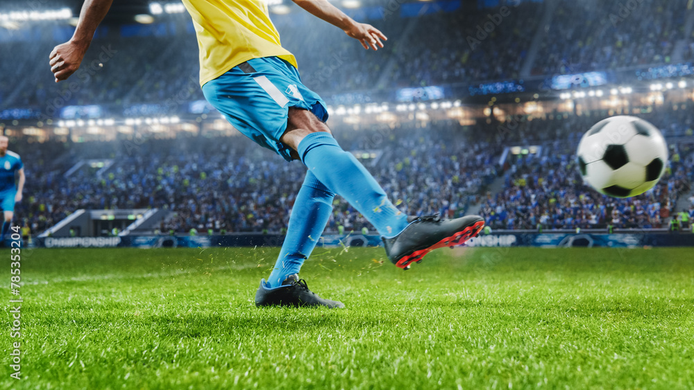 Naklejka premium Aesthetic Shot Of Athletic Hispanic Footballer Shooting A Penalty Kick On Stadium With Crowd Cheering. Player Scoring a Goal At an International Soccer Championship Final Match With Fans On Tribune