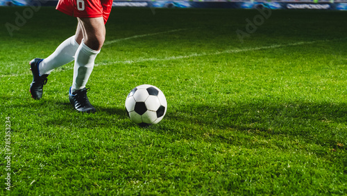 Close-Up On Legs Of Professional Football Player Dribbling With A Ball During International Soccer Championship On National Arena. Athlete Running To Score A Winning Goal In Final Match On Stadium. © Gorodenkoff